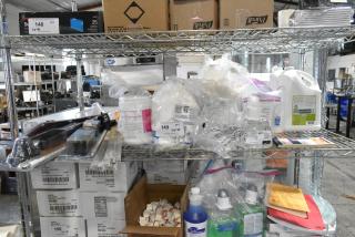 Tier lot of assorted items including CB antenna, CaviWipes, Scott foam skin cleanser, Diversey dry wipes, on shelves.