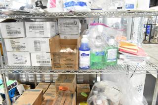 Tiered shelf with Vistar ketchup pouches, Delight Half and Half creamer, Diversey Crew Super Blue cleaner, and security badge holders in zip bags.