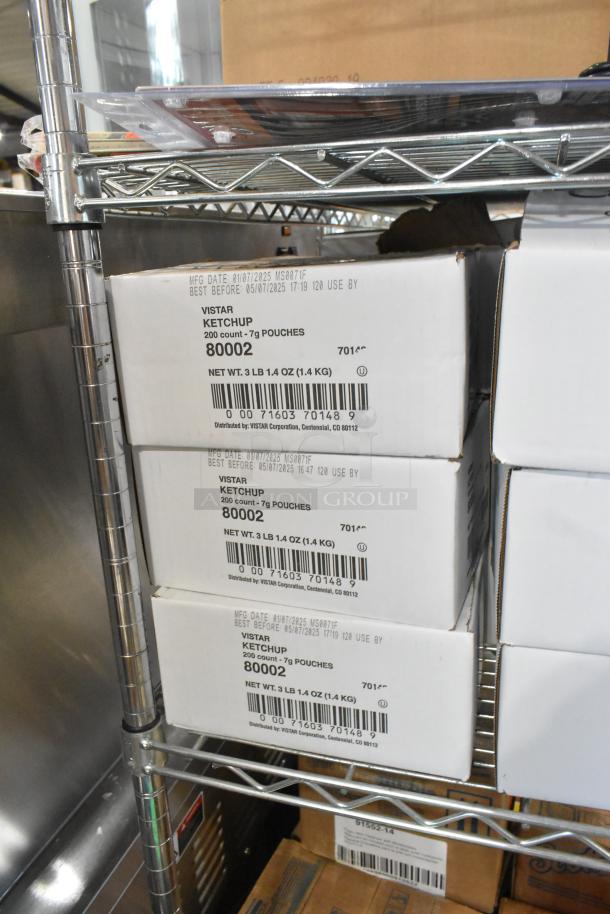 Boxes of Vistar ketchup, 200 count of 7g pouches, visible labels with expiration date and weight on metal shelf.