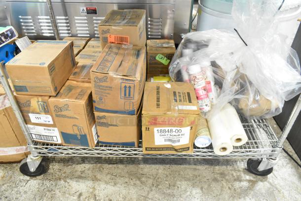 ALL ONE MONEY! Tier lot with Scott dispenser, foam skin cleanser, daily scrub, and various boxed items on metal cart.