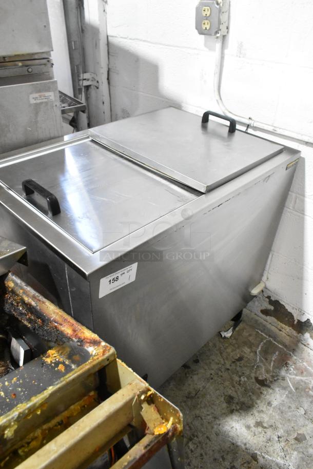 Silver King stainless steel commercial chest freezer on casters, in good condition, 115V, 1 phase, with side handle.