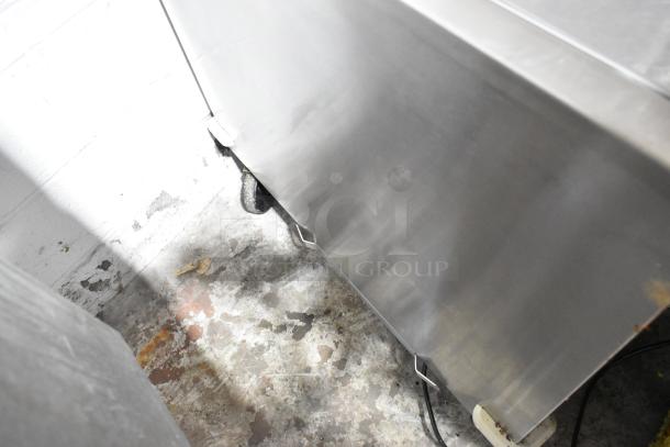 Silver King stainless steel commercial chest freezer, 115 volts, 1 phase, on casters, visible wear on the exterior.