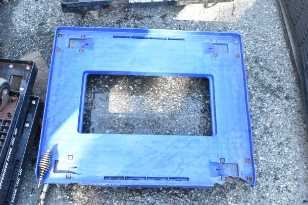 5 blue furniture dollies with commercial casters on rough surface, showing wear and rust on edges.