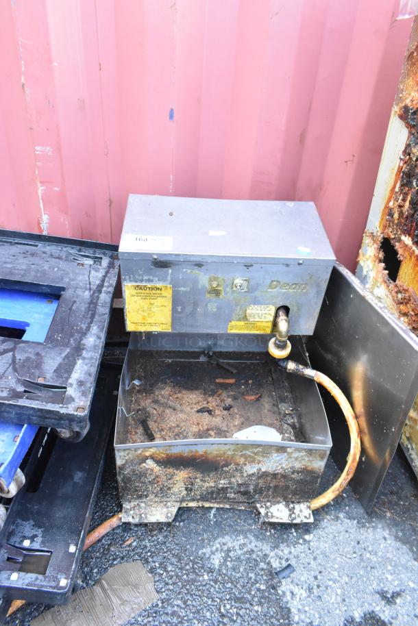 Dean stainless steel commercial fryer oil filtration system, visible wear, caution labels, hose attached.