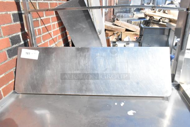 Stainless steel shelf with brushed finish, rectangular shape, slight scuffs, tag reading "161", suitable for industrial use.