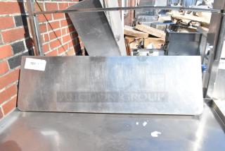 Stainless steel shelf with brushed finish, rectangular shape, slight scuffs, tag reading "161", suitable for industrial use.