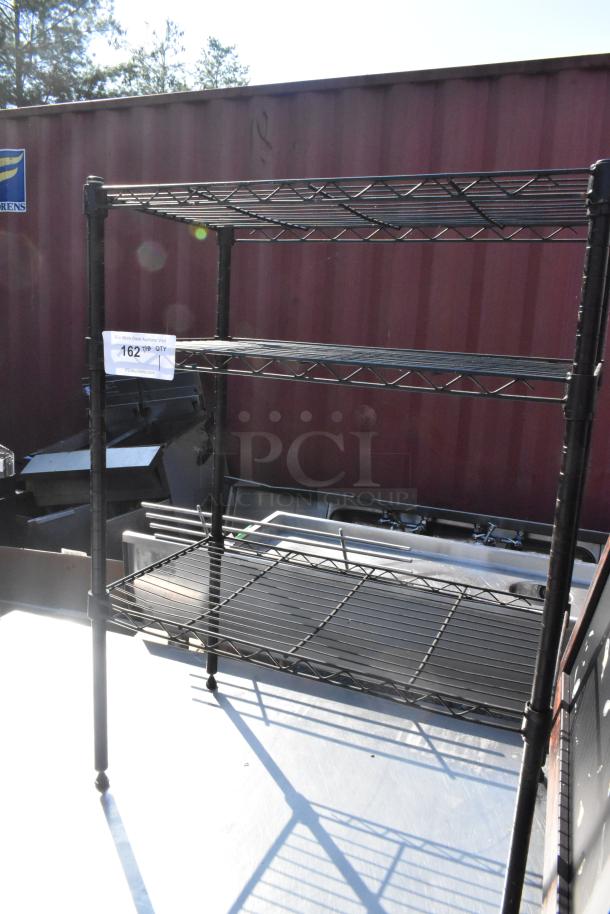 Black finish 3-tier wire shelving unit, sturdy condition, buyer must dismantle. Additional freight charges apply.