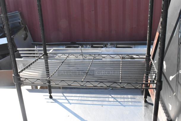 Black finish 3-tier wire shelving unit, sturdy construction, in good condition. Buyer must dismantle for shipping; consider freight charges.