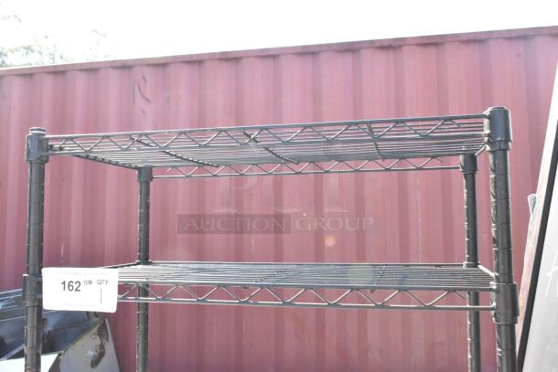 Black finish 3 tier wire shelving unit, dismantling required, visible auction label.
