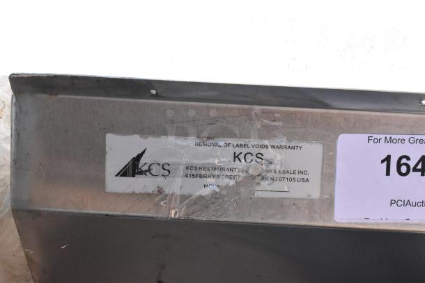 Stainless steel 3 bay sink with faucet, KCS label visible, minor surface wear, warranty void if label removed.