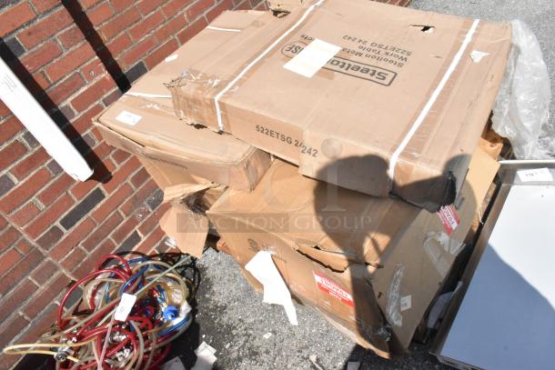 Four new scratch and dent items in boxes, including a black metal crossback chair and chrome bar frame. Boxes marked "Steelers."