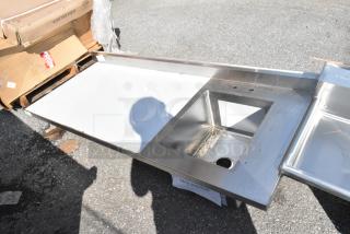BRAND NEW SCRATCH AND DENT Regency 600ST3072R stainless steel table with sink bay, missing legs, visible minor damage.