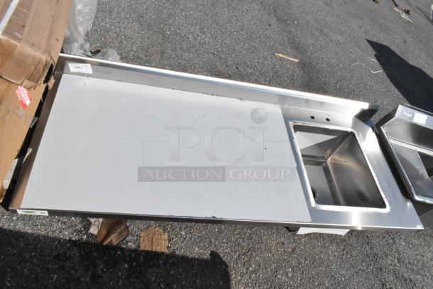 Brand new Regency 600ST3072R stainless steel table with sink bay, no legs. Minor scratches, for commercial kitchen use.
