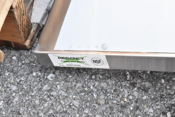 Regency 600ST3072R stainless steel table with sink bay, brand new scratch and dent, no legs, NSF certified label visible.