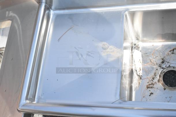 Brand new KoolMore SB151512-15L3 stainless steel 2 bay sink with left side drain board. Slight scratches and debris visible.