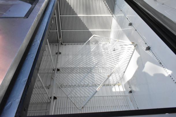 True T-49F Stainless Steel 2 Door Reach-In Freezer, includes poly-coated racks, interior view showing shelving.