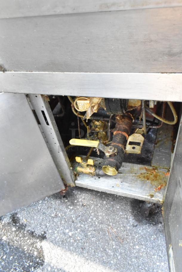 Frymaster FPH350CSD stainless steel commercial fryer, 2-bay, natural gas-powered, 80,000 BTU. Interior view of plumbing.
