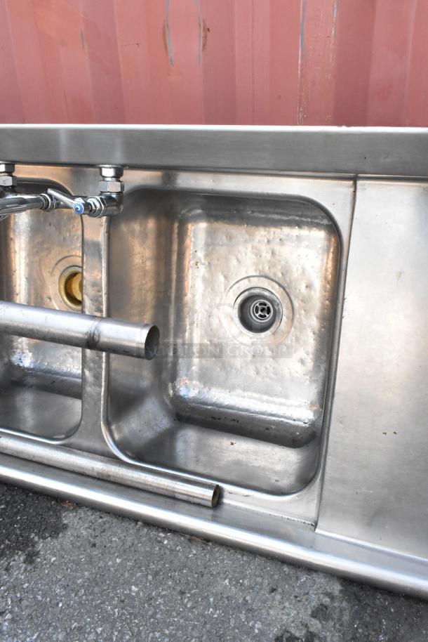 Stainless steel 3-bay sink with dual drain boards, faucet and handles; used condition, ideal for commercial kitchens.