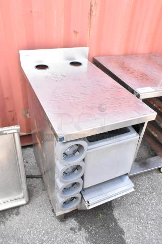 Stainless steel counter with four built-in cup dispensers, featuring a sleek design. Appears in good condition.
