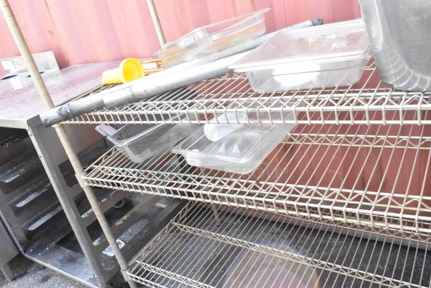 Chrome finish 4-tier wire shelving unit with various contents. Buyer must dismantle. Consider freight charges.