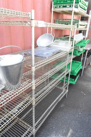 Chrome finish 5-tier wire shelving unit with assorted contents, includes bucket and trays. Buyer must dismantle.