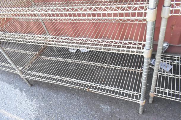 Chrome finish 5-tier wire shelving unit, visibly worn, with contents. Dismantling and freight required for transport.