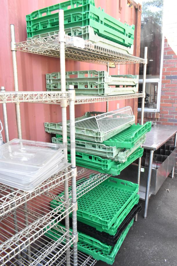 Chrome finish 4-tier wire shelving unit with assorted trays. Good condition. Buyer responsible for dismantling.