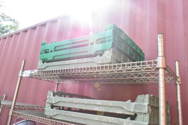 Chrome finish 4-tier wire shelving unit with stacked green and gray crates. Shelves include visible label tags.