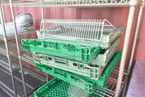 Chrome finish 4-tier wire shelving unit with assorted contents, including green plastic trays and metal items. Buyer to dismantle.