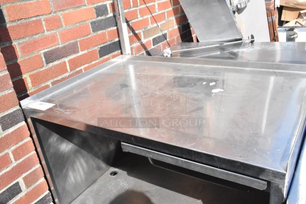 Stainless steel cart with under shelf and commercial casters, minor wear, perfect for kitchen or industrial use.