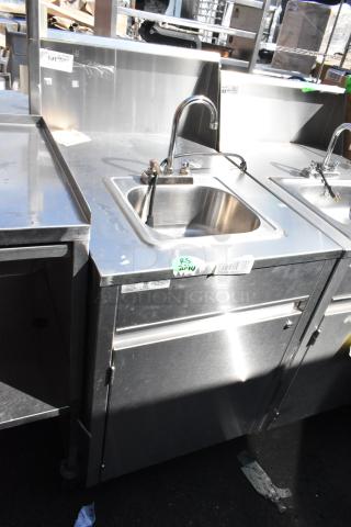 QualServ stainless steel portable sink on commercial casters, features faucet and basin, good condition, visible barcode label.