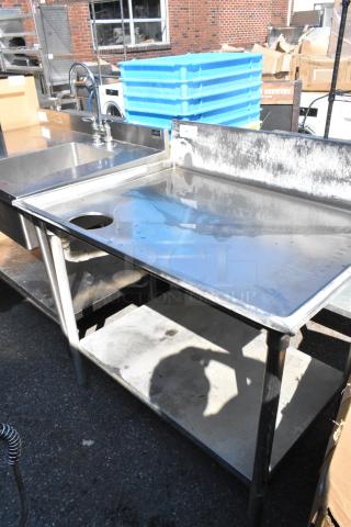 Stainless steel table with cut-out, under shelf, and backsplash. Used condition, ideal for industrial kitchens.