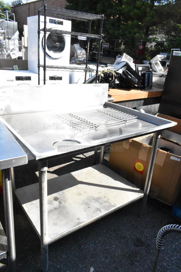 Stainless steel table with cut out, under shelf, and backsplash. Used condition, ideal for kitchen or workshop.