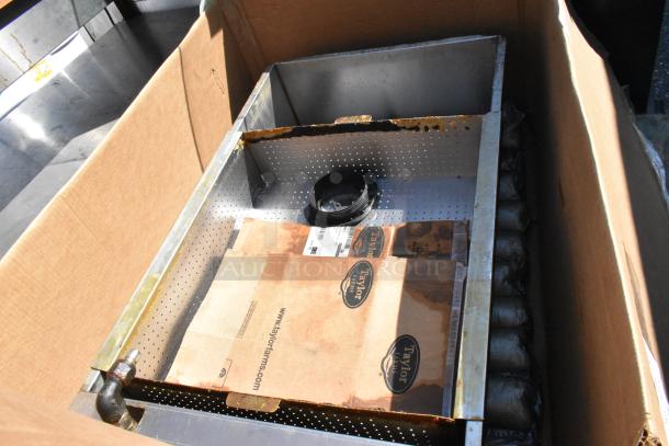 Metal unit in cardboard box, features perforated steel frame, visible rust, and Taylor Farms cardboard with product information.