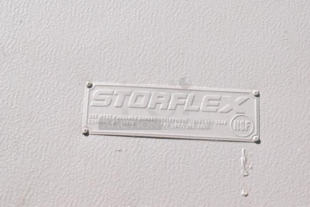 Storflex Walk In Box Door with Frame, textured surface, features a metal label indicating the brand, contact details, and NSF mark.