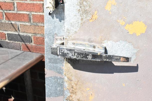 Storflex Walk In Box Door with frame, featuring a metal handle. Door surface shows signs of wear and paint chipping.