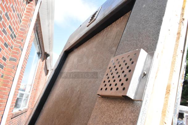 Storflex walk-in box door with frame, featuring a perforated metal panel, sturdy condition, suitable for commercial use.