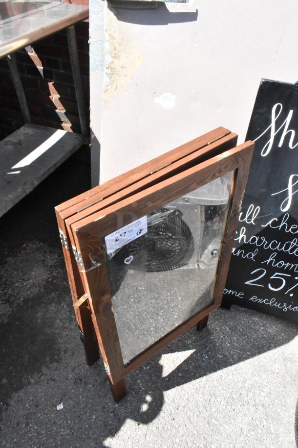 Two wooden A-frame sidewalk signs, clear panels, used condition, lot number visible on label.