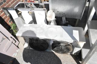 HTA28-97B-A700 Metal Evaporator Fan, 115V, 1 Phase, dual fan design, visible wear, outdoor setting.