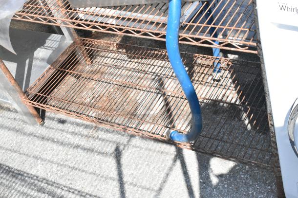 Chrome finish 4-tier wire shelving unit with rust. Buyer must dismantle. Consider freight charges.