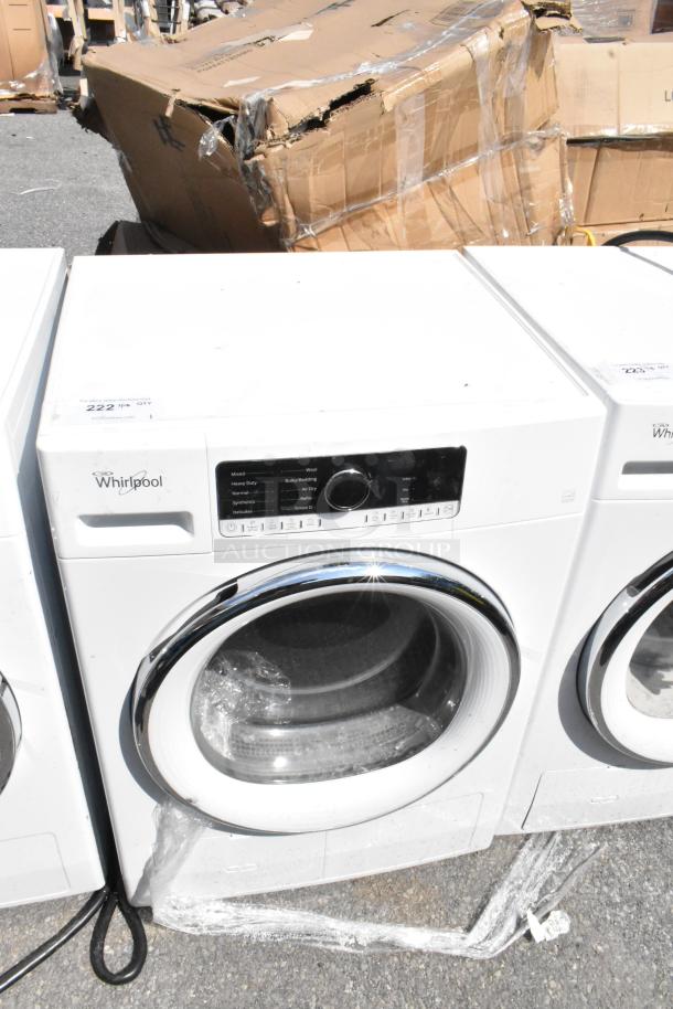 Whirlpool front load dryer, metal finish, used condition. Features control panel with multiple settings. Model details not visible.