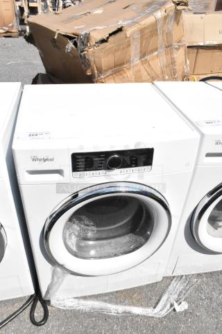 Whirlpool front load dryer, metal finish, used condition. Features control panel with multiple settings. Model details not visible.