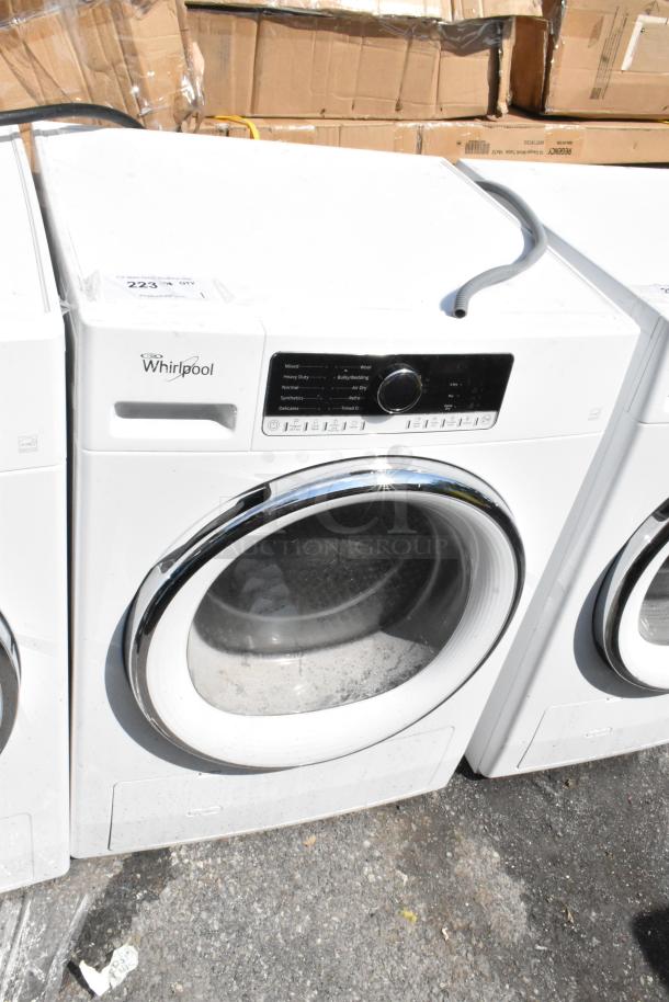 Whirlpool front load dryer, metal model, white finish, visible control panel, used condition with minor scuffs.