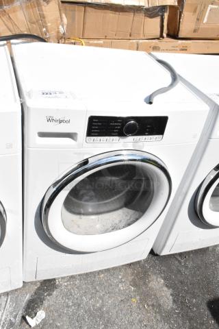 Whirlpool front load dryer, metal model, white finish, visible control panel, used condition with minor scuffs.