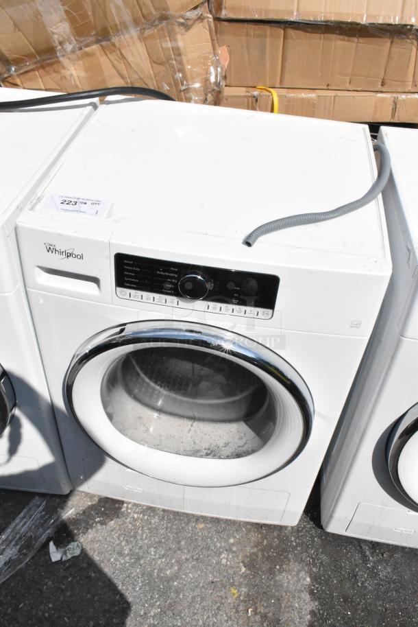 Whirlpool front load dryer, white metal, in fair condition. Features multiple drying cycles. Visible user control panel. Model tag intact.
