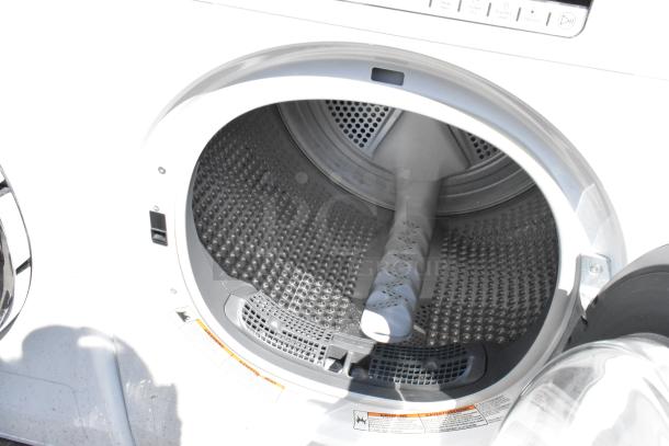 Whirlpool front load dryer, metal interior, open door view, visible control panel, excellent condition.