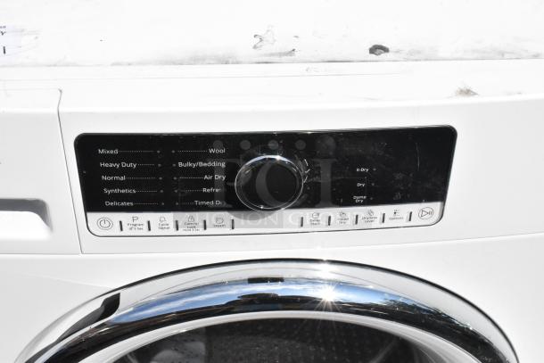 Whirlpool front load dryer, metal finish, control panel with multiple settings, good condition.