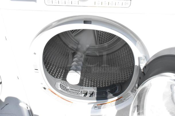 Whirlpool front load dryer, metal drum, open door view, model in good condition. Control panel visible.