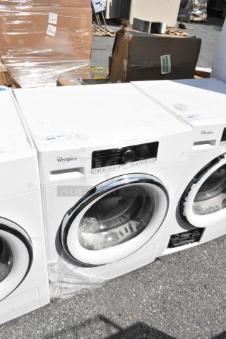 Whirlpool front load dryer, metal finish, electronic control panel, moderate wear, model information visible on control panel.
