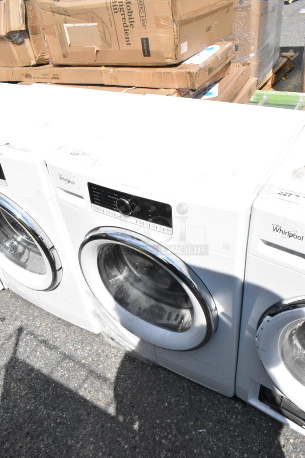 Whirlpool front load dryer with metal finish, featuring a digital control panel. Appears in good condition.